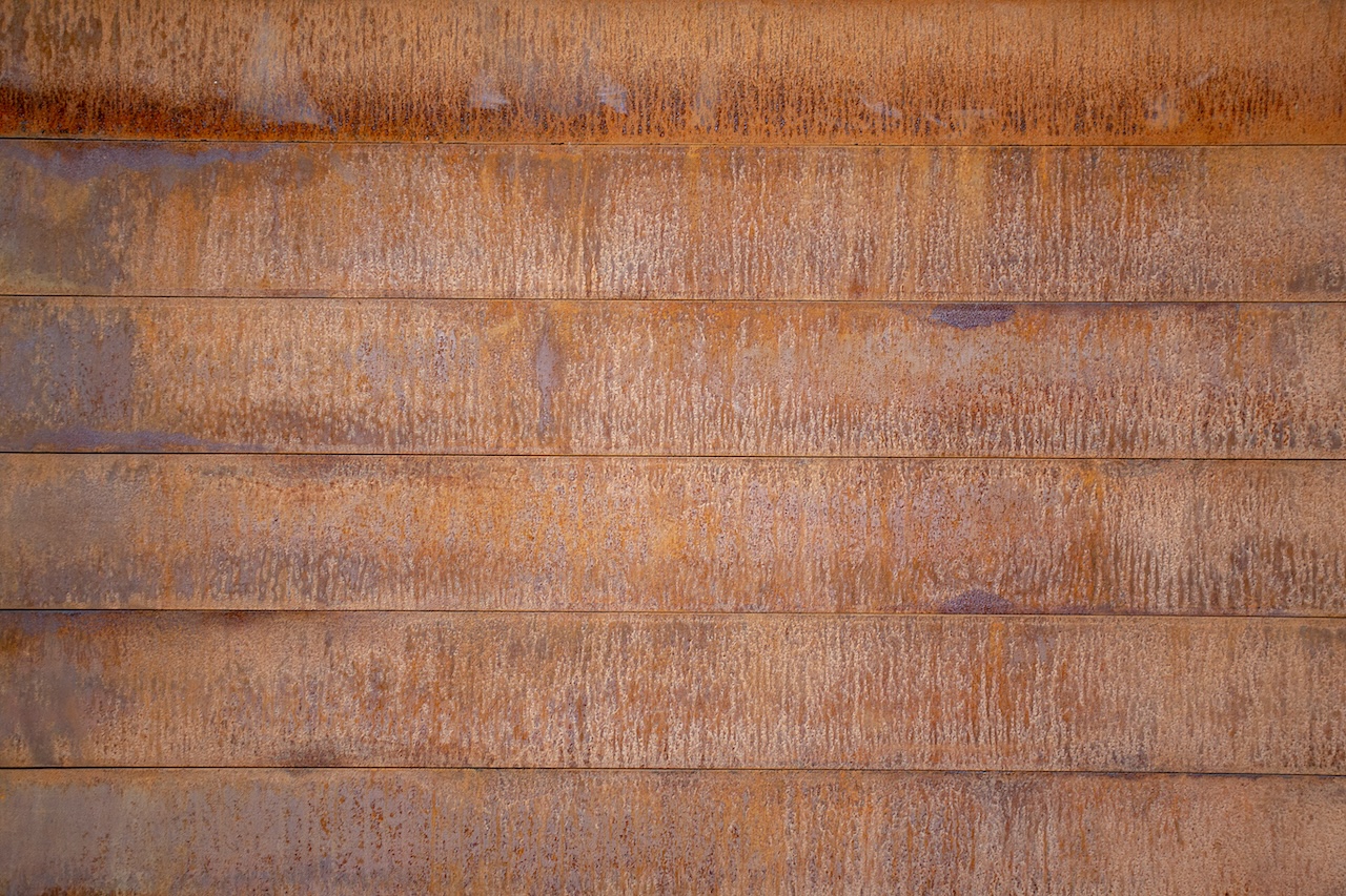 Steel rust red corten panels planks wall of red rust background horizontal image